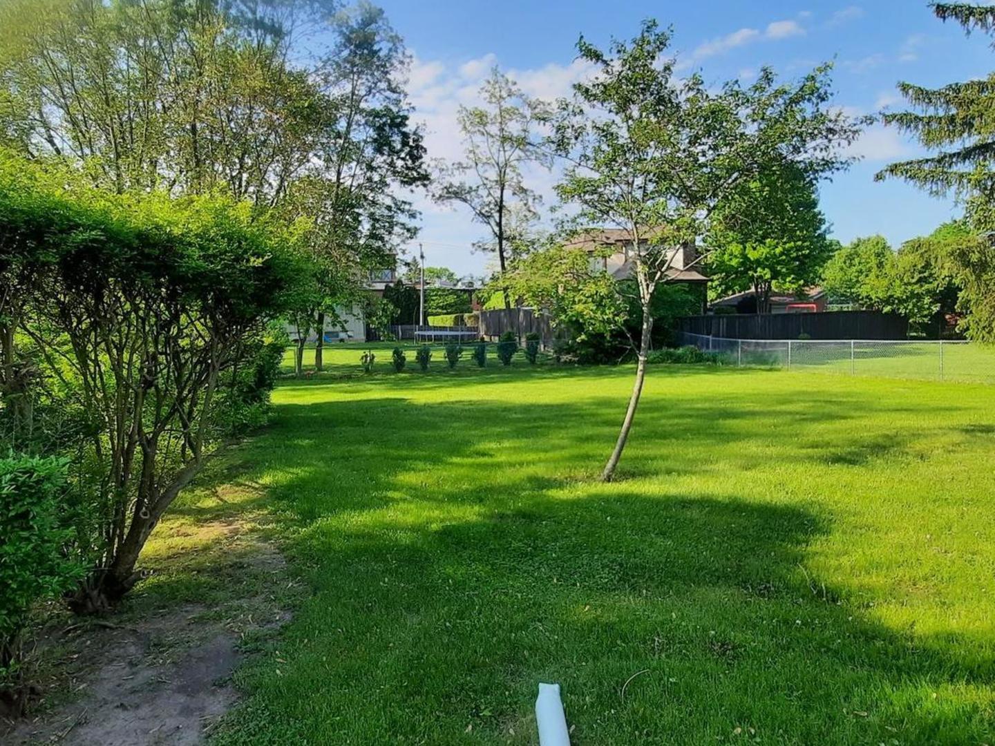 240 West Tower Road Barrington, IL 60010 - Photo 3 of 17 a view of a park with a tree in the grass