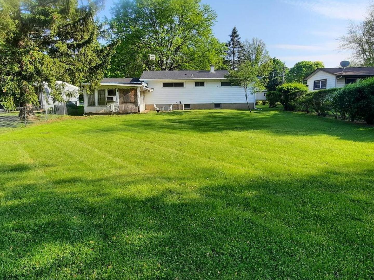 240 West Tower Road Barrington, IL 60010 - Photo 5 of 17 a view of a house with a yard deck and a tree