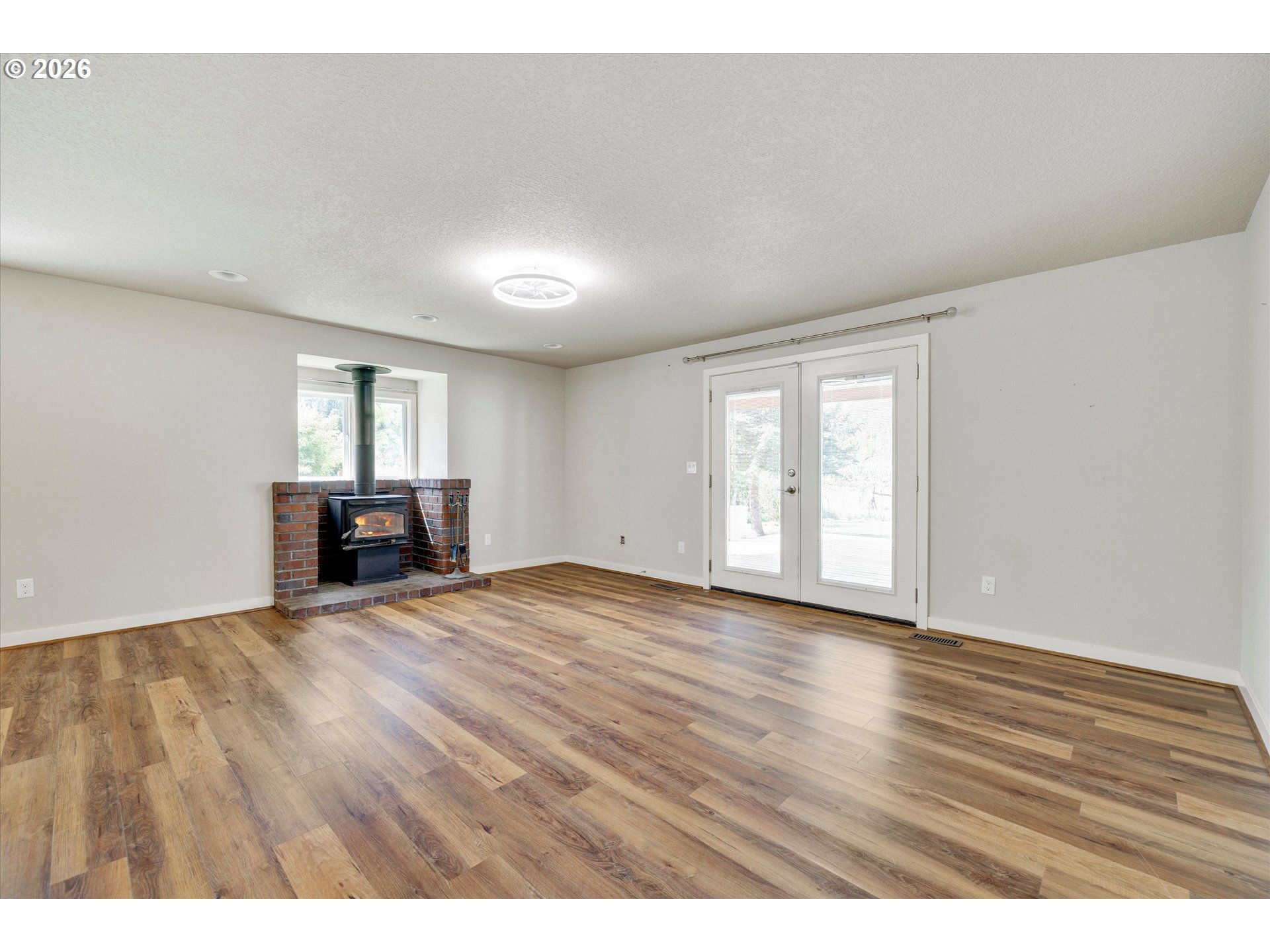17139 South Bradley Road Oregon City, OR 97045 - Photo 12 of 47 a view of an empty room with window and wooden floor