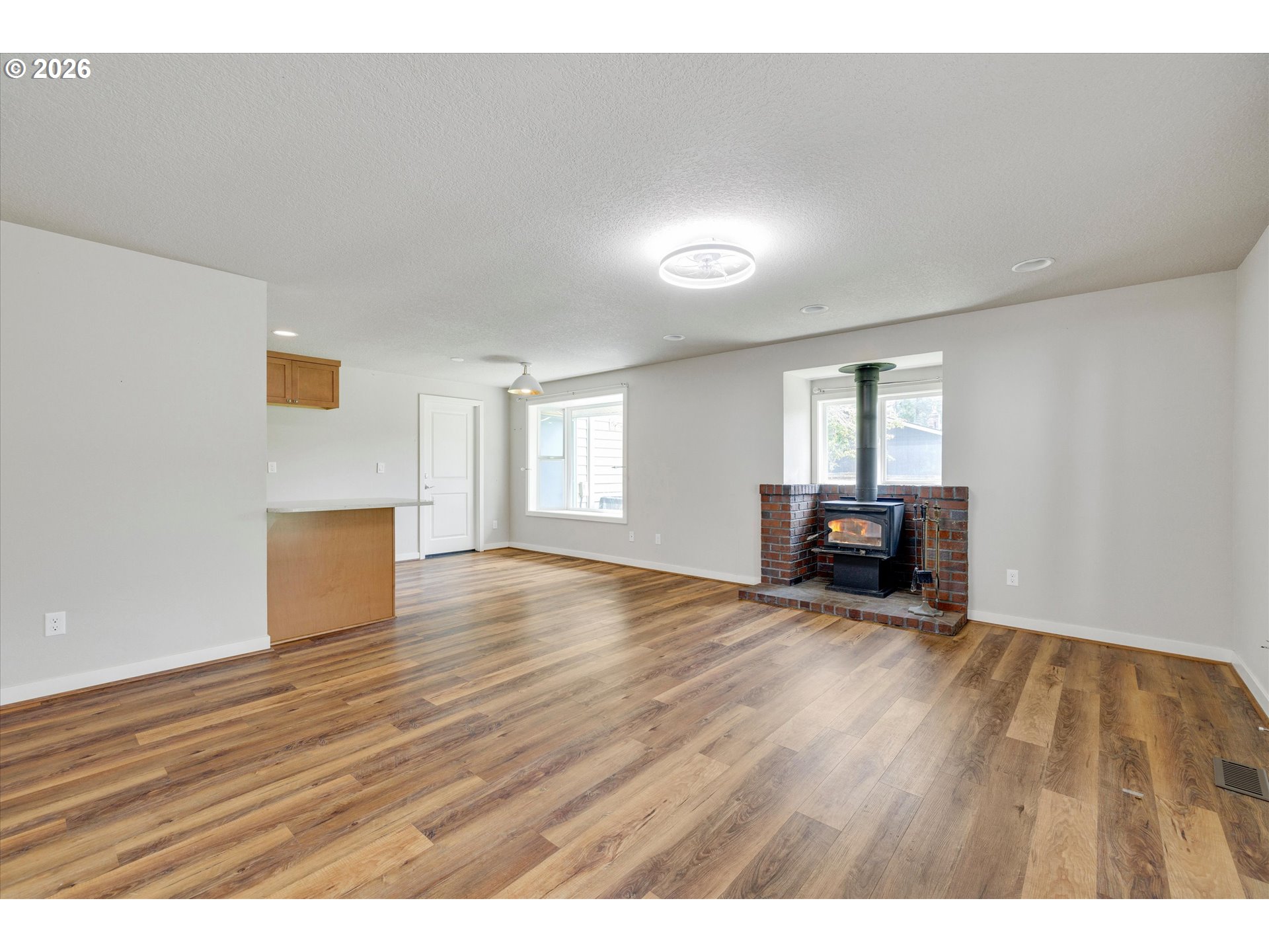 17139 South Bradley Road Oregon City, OR 97045 - Photo 13 of 47 a view of an empty room with wooden floor and a window