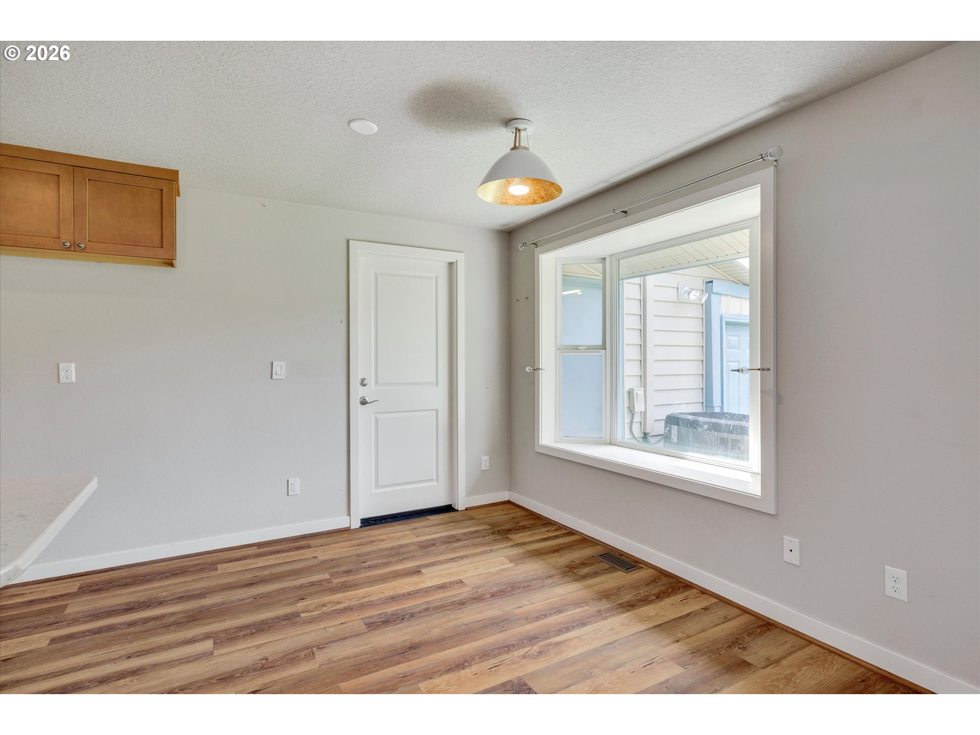 17139 South Bradley Road Oregon City, OR 97045 - Photo 16 of 47 a view of an empty room with wooden floor and a window