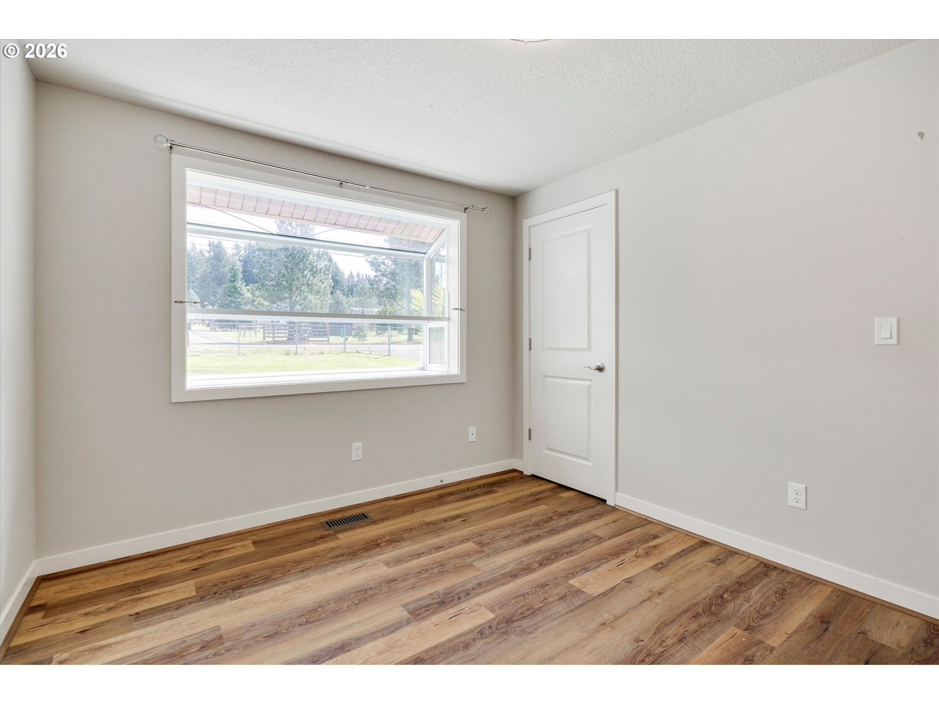 17139 South Bradley Road Oregon City, OR 97045 - Photo 20 of 47 an empty room with wooden floor and windows