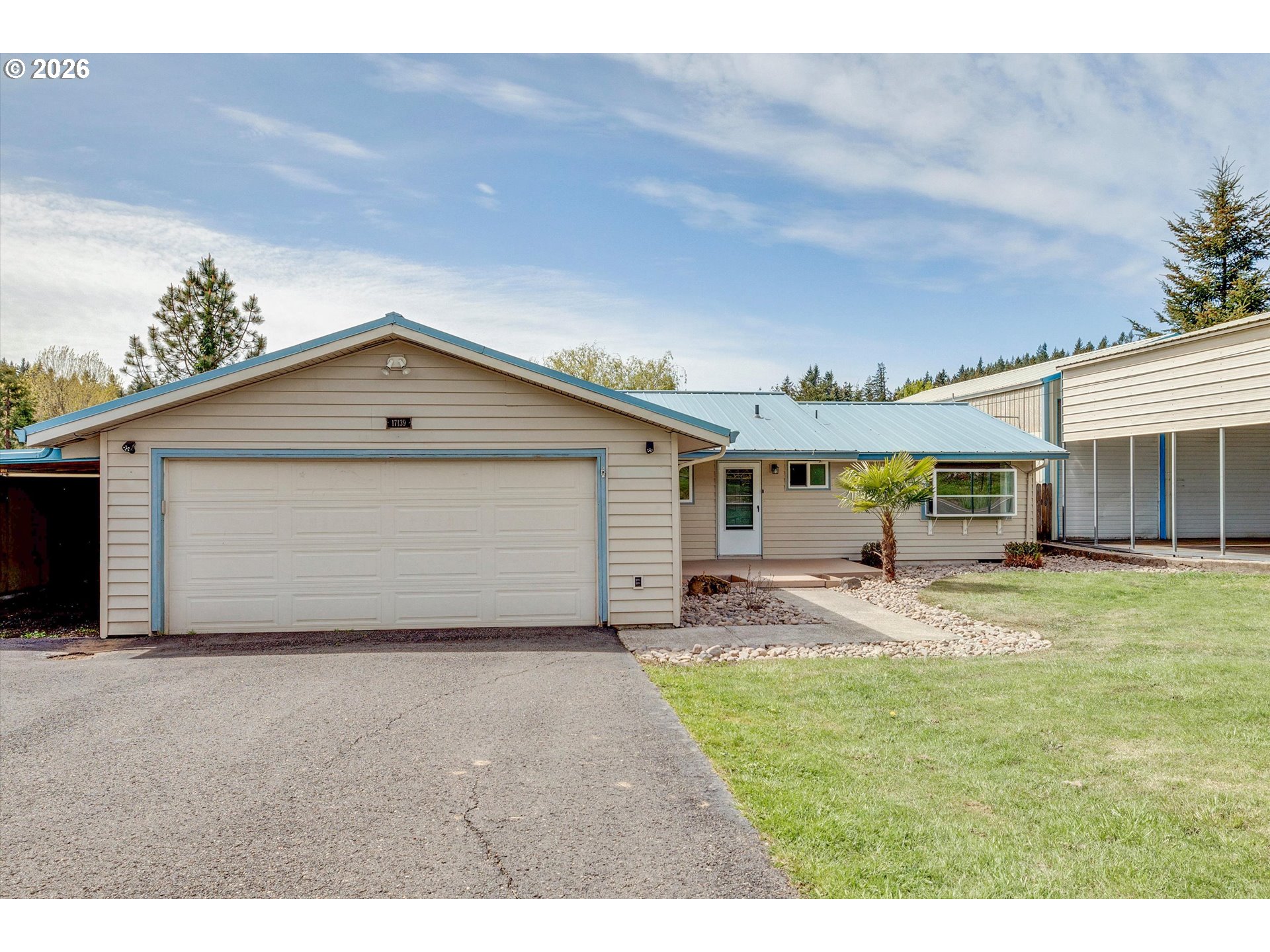 17139 South Bradley Road Oregon City, OR 97045 - Photo 3 of 47 a front view of house with yard and trees in the background