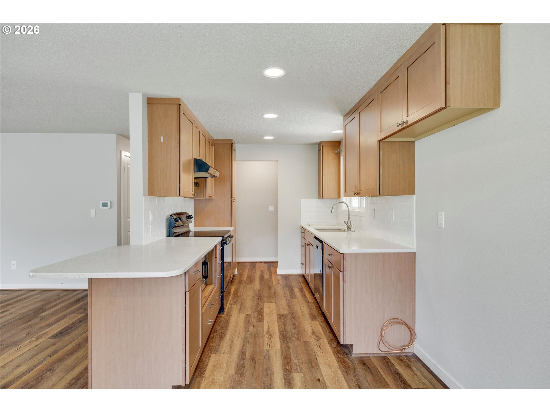 17139 South Bradley Road Oregon City, OR 97045 - Photo 7 of 47 a kitchen with kitchen island a sink stove and wooden cabinets