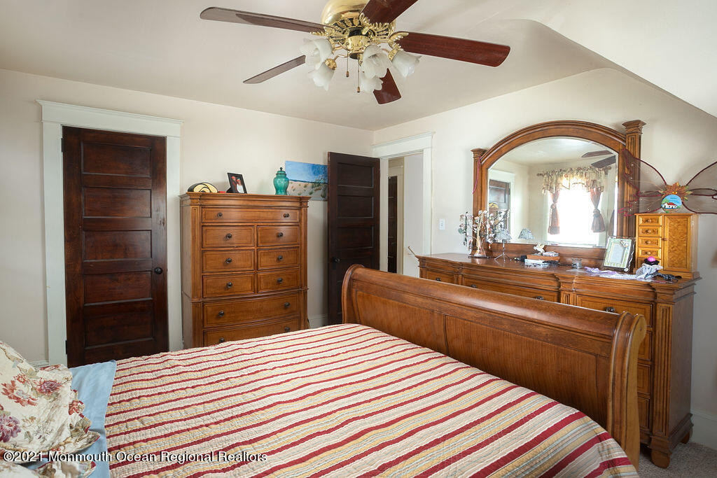 48 Ridgway Street Mount Holly, NJ 08060 - Photo 12 of 24 a bedroom with a bed and a chandelier