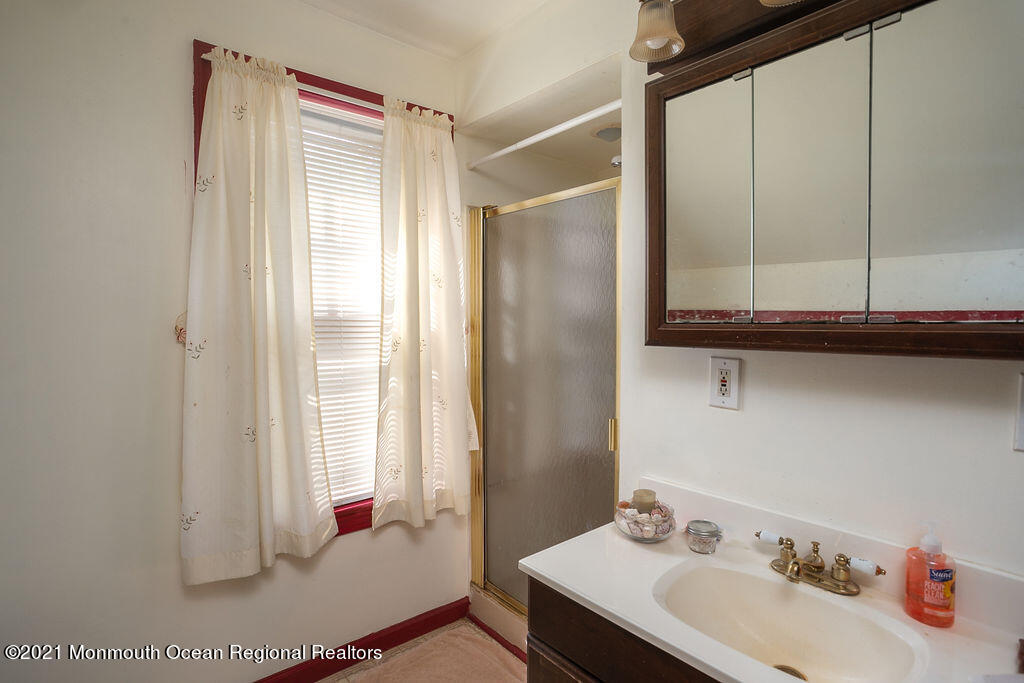 48 Ridgway Street Mount Holly, NJ 08060 - Photo 14 of 24 a bathroom with a sink and a mirror
