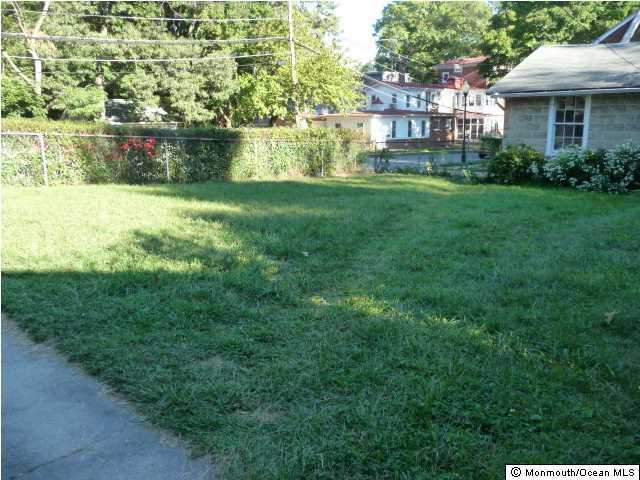 48 Ridgway Street Mount Holly, NJ 08060 - Photo 20 of 24 a view of a brick house with a big yard and large trees