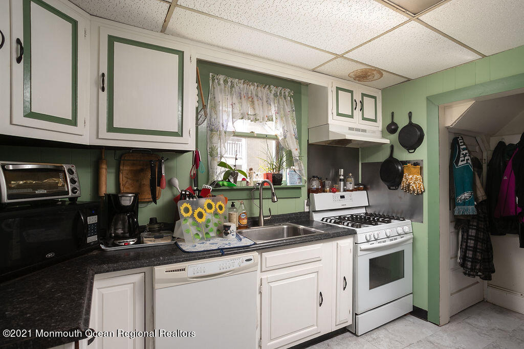 48 Ridgway Street Mount Holly, NJ 08060 - Photo 8 of 24 a kitchen with stainless steel appliances granite countertop a sink stove and cabinets