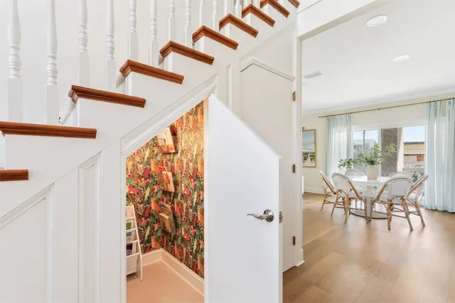 a view of a livingroom with furniture and staircase