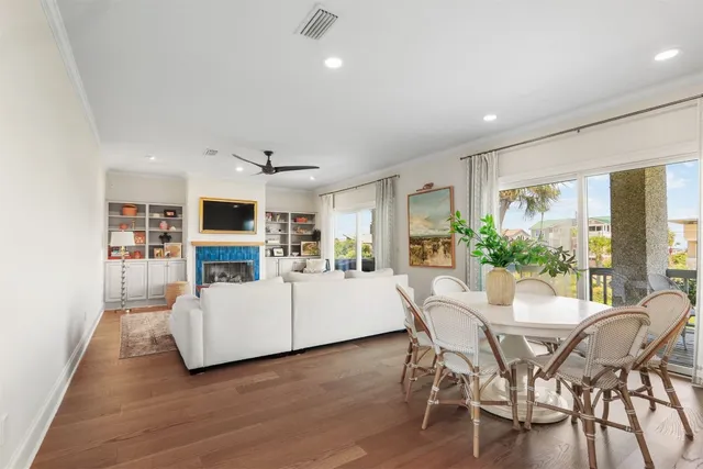 a view of a dining room with furniture and a kitchen view