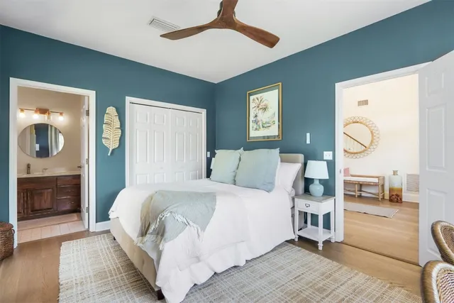 a bedroom with a large bed and a chandelier