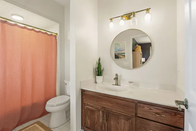 a bathroom with a toilet a sink and a mirror