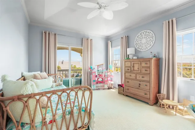 a bedroom with furniture and a large window