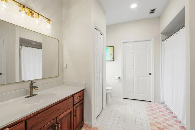 a spacious bathroom with a sink and a mirror