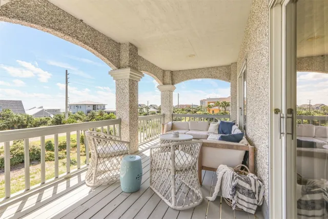 a living room with furniture and floor to ceiling windows