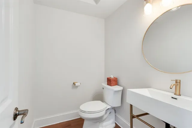 a white toilet sitting next to a bathroom sink