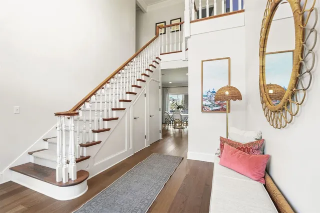 a view of entryway and hall with wooden floor
