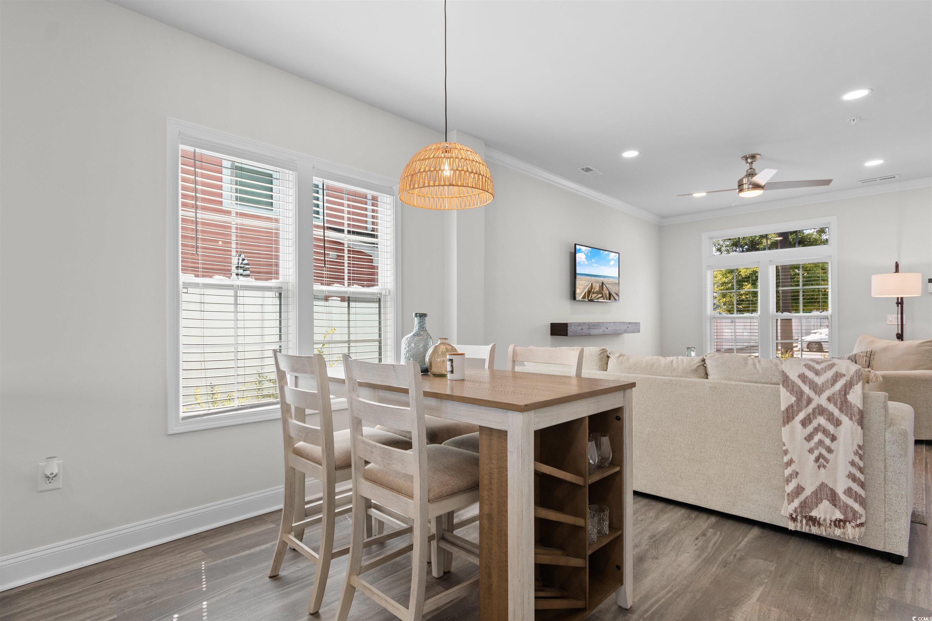 804 Moen Place, Unit F Myrtle Beach, SC 29577 - Photo 10 of 34 Dining area with wood finished floors, ceiling fan, recessed lighting, and ornamental molding