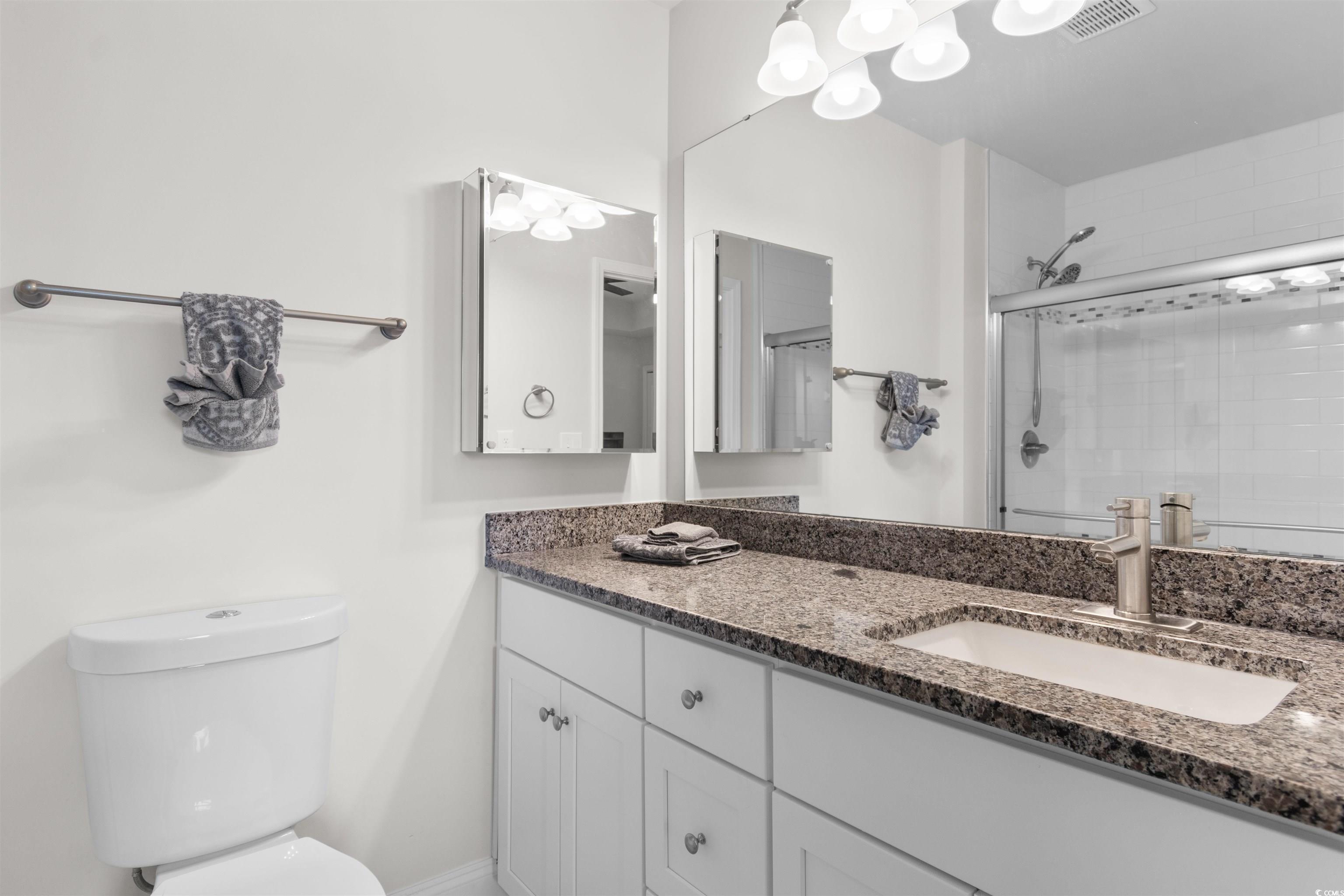 804 Moen Place, Unit F Myrtle Beach, SC 29577 - Photo 18 of 34 Bathroom featuring a stall shower and vanity