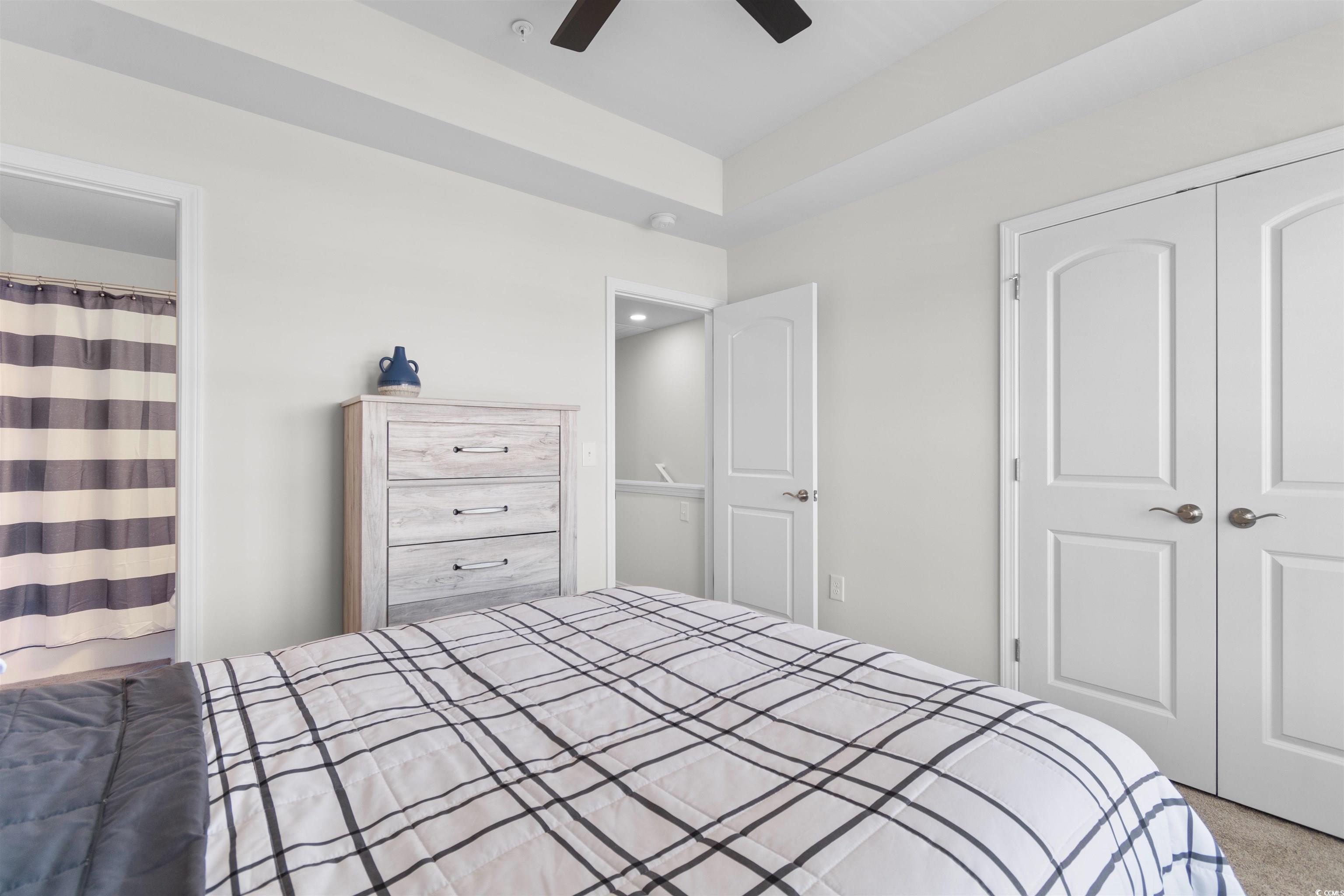 804 Moen Place, Unit F Myrtle Beach, SC 29577 - Photo 20 of 34 Bedroom featuring a closet, carpet, and ceiling fan