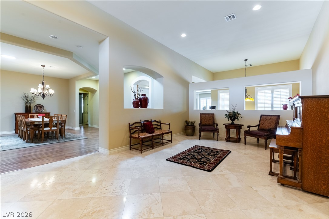 3661 Riley Ann Avenue Las Vegas, NV 89139 - Photo 5 of 42 Natural light illuminates this spacious living area with refined tile and wood flooring.