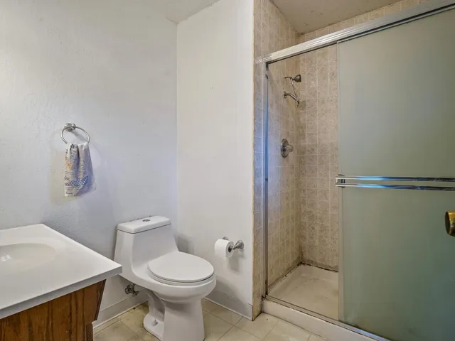 a bathroom with a toilet a sink and shower