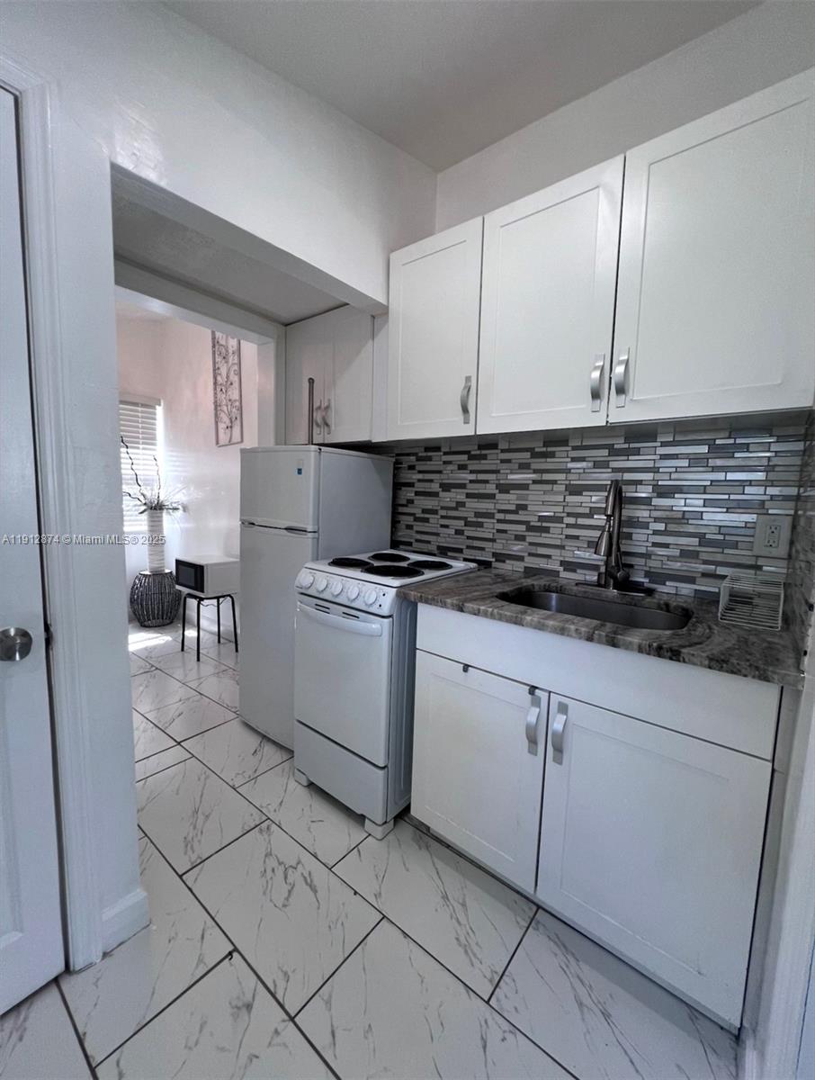 624 Northeast 205th Terrace Miami, FL 33179 - Photo 6 of 10 a kitchen with cabinets and window