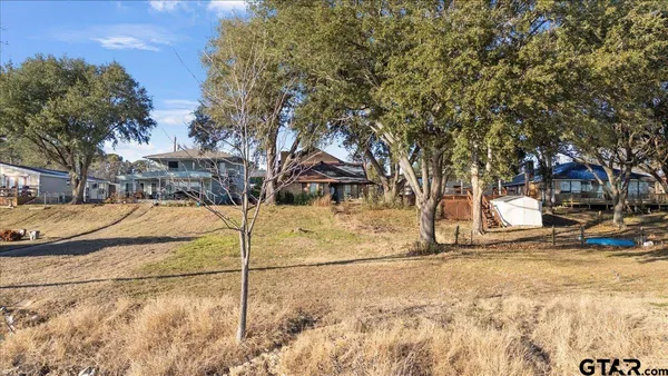 a view of a yard with snow on the road