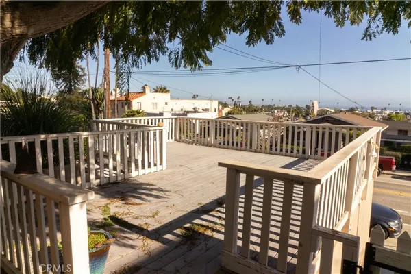 a view of balcony with wooden floor and outdoor seating