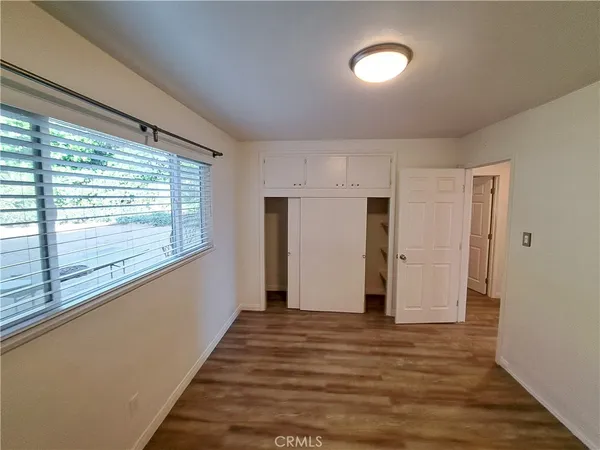 a view of a room with wooden floor and window
