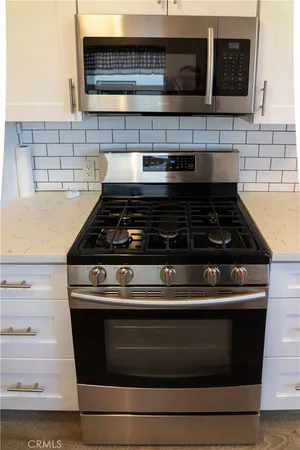 a stove top oven sitting inside of a kitchen