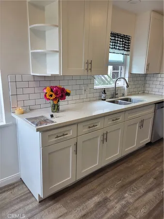 a kitchen with sink cabinets and window