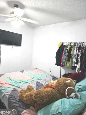 a white toilet sitting next to a shower curtain