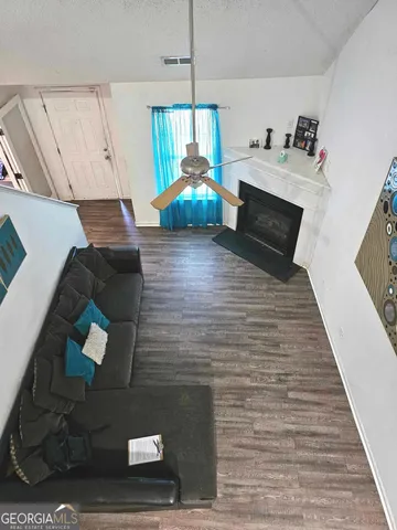 a living room with furniture and a wooden floor