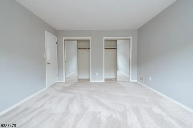 a view of an empty room with closet