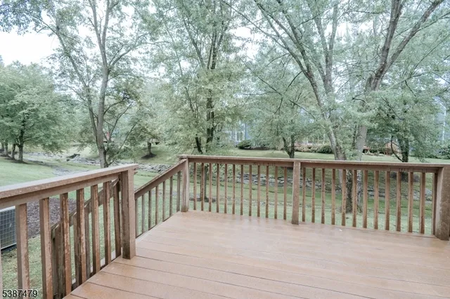 a balcony with wooden floor and fence