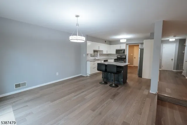a view of a kitchen with a table and chairs