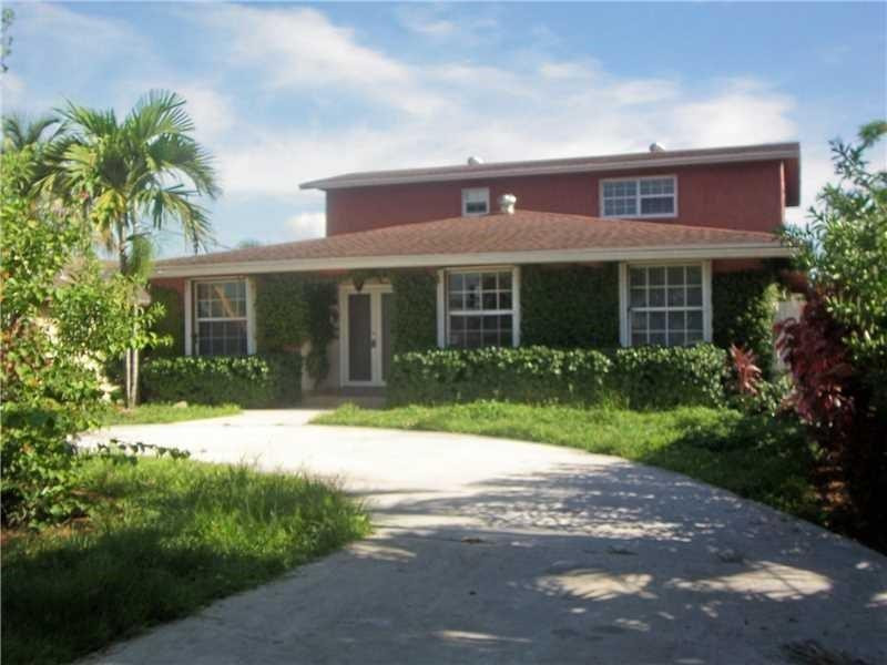 12031 Southwest 7th Street Miami, FL 33184 - Photo 1 of 12 a front view of house with yard and green space