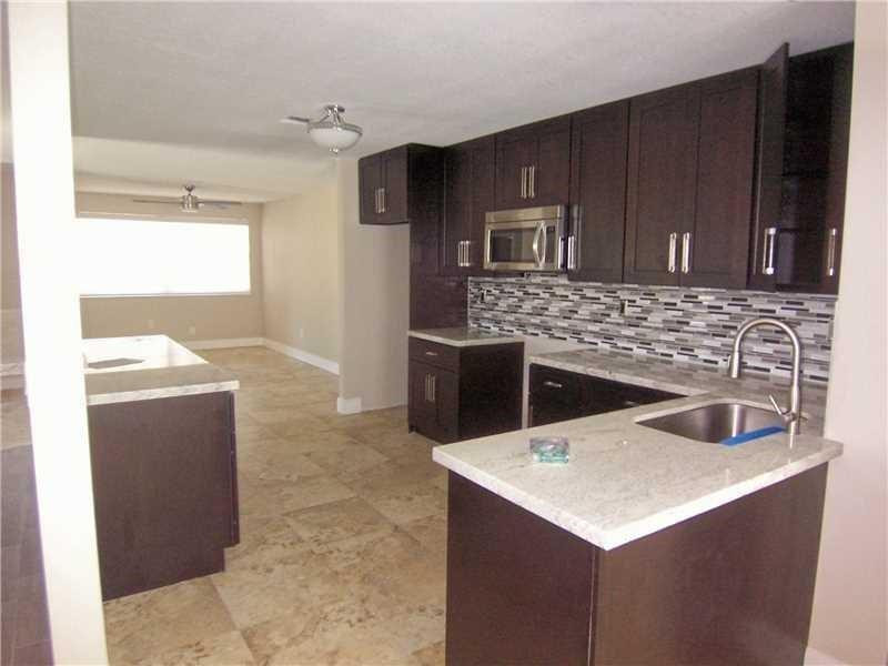12031 Southwest 7th Street Miami, FL 33184 - Photo 2 of 12 a kitchen with granite countertop a sink a stove and refrigerator