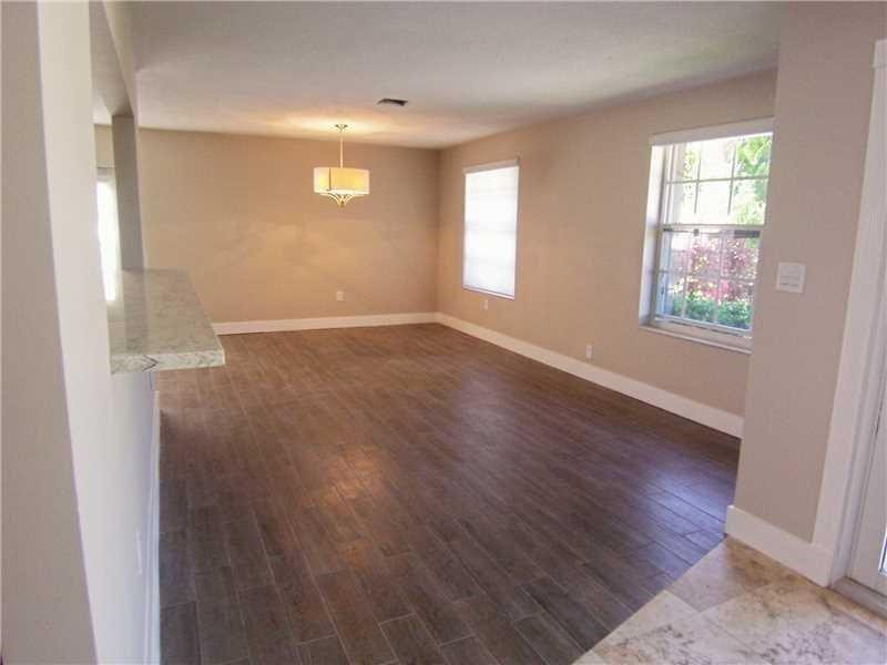 12031 Southwest 7th Street Miami, FL 33184 - Photo 3 of 12 an empty room with wooden floor and windows
