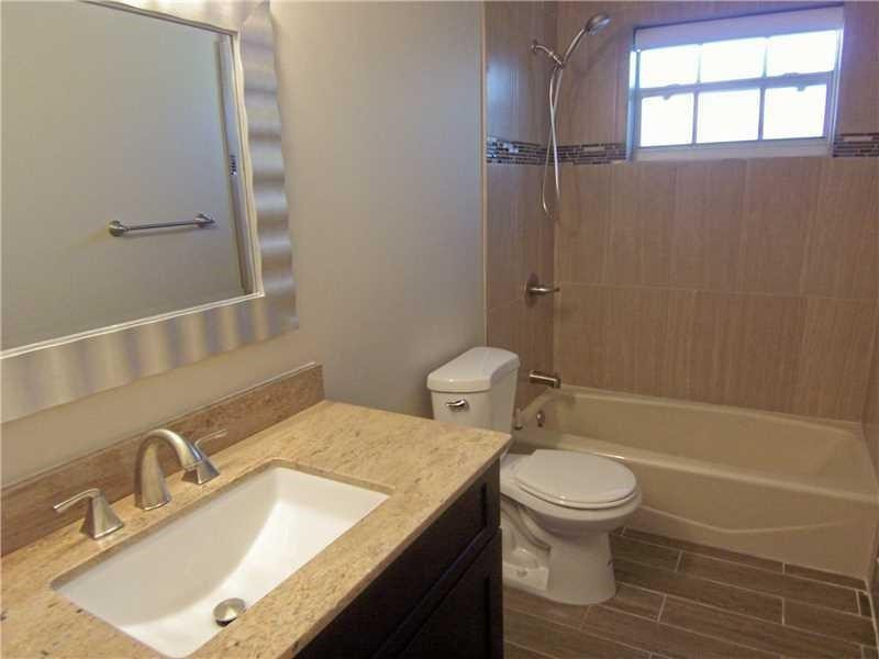 12031 Southwest 7th Street Miami, FL 33184 - Photo 5 of 12 a bathroom with a granite countertop sink toilet and shower