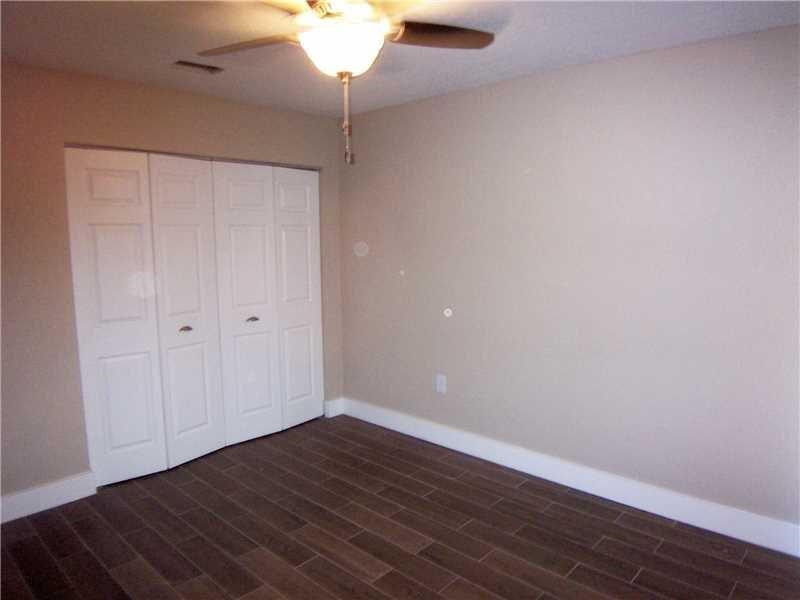 12031 Southwest 7th Street Miami, FL 33184 - Photo 9 of 12 a view of an empty room with wooden floor