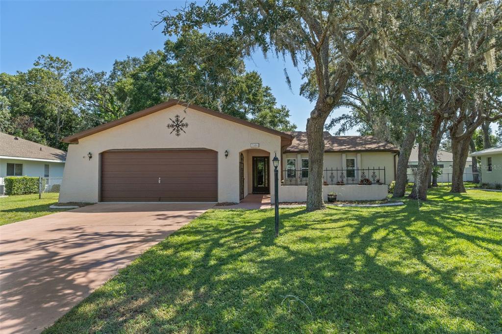 7606 Landmark Drive Spring Hill, FL 34606 - Photo 2 of 41 a front view of a house with a yard and garage