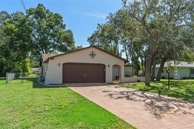 a front view of house with yard and trees