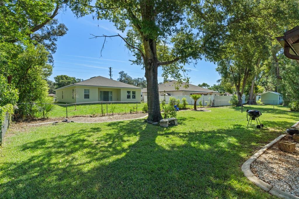 7606 Landmark Drive Spring Hill, FL 34606 - Photo 31 of 41 a front view of a house with a yard table and chairs