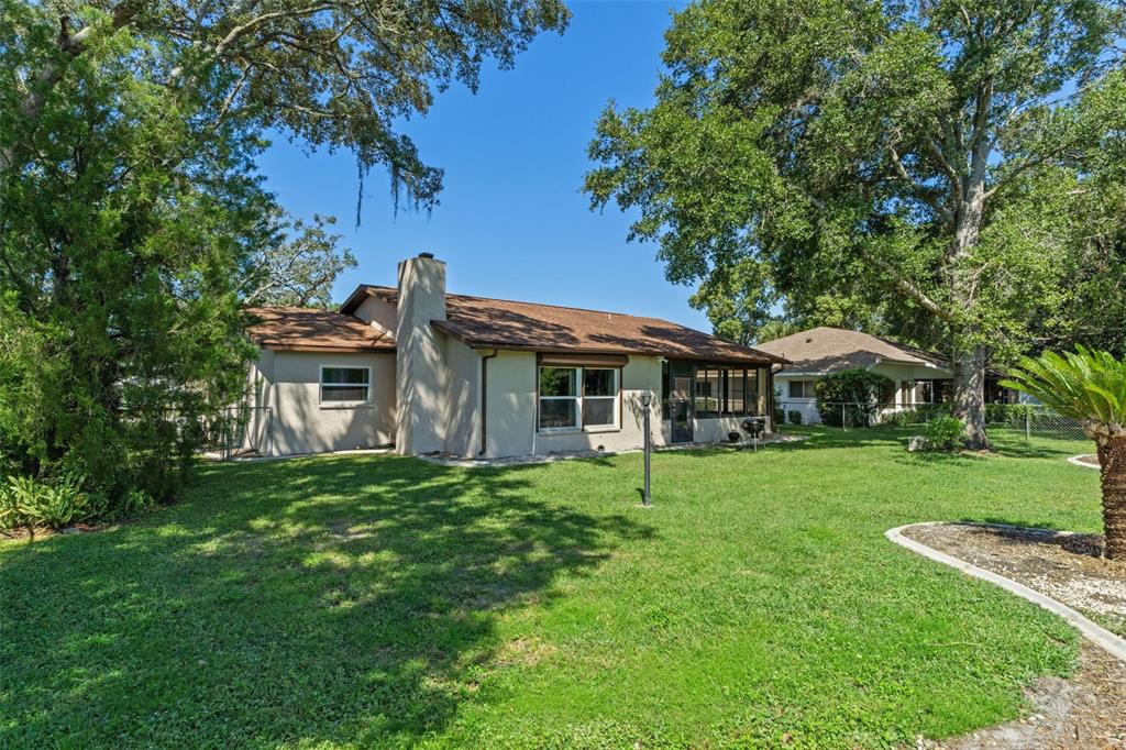 7606 Landmark Drive Spring Hill, FL 34606 - Photo 33 of 41 a front view of a house with a garden