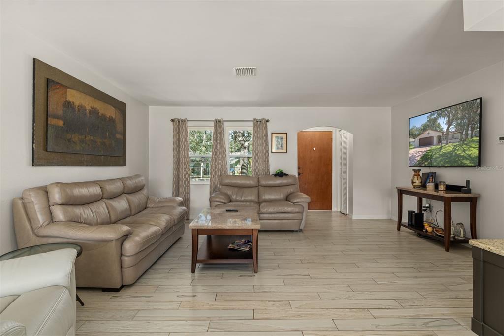 7606 Landmark Drive Spring Hill, FL 34606 - Photo 6 of 41 a living room with furniture and a flat screen tv
