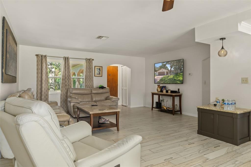 7606 Landmark Drive Spring Hill, FL 34606 - Photo 7 of 41 a living room with furniture and a wooden floor