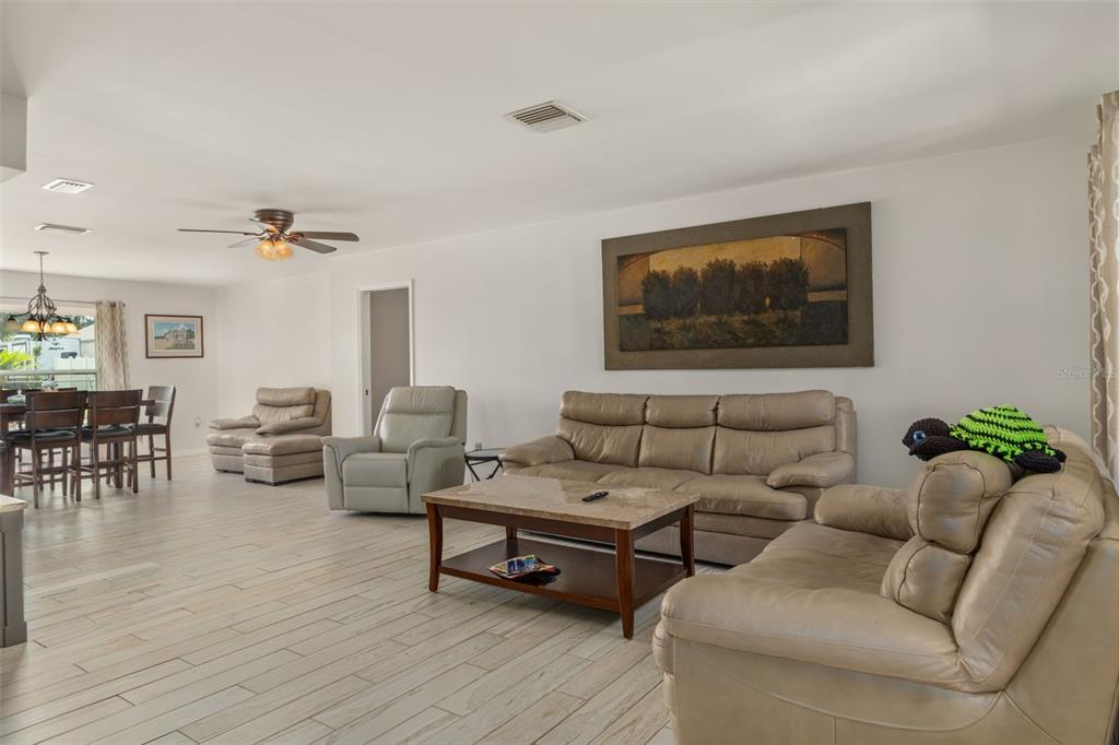 7606 Landmark Drive Spring Hill, FL 34606 - Photo 8 of 41 a living room with furniture and wooden floor