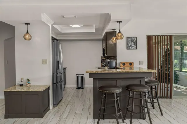 a view of a kitchen area with furniture and wooden floor